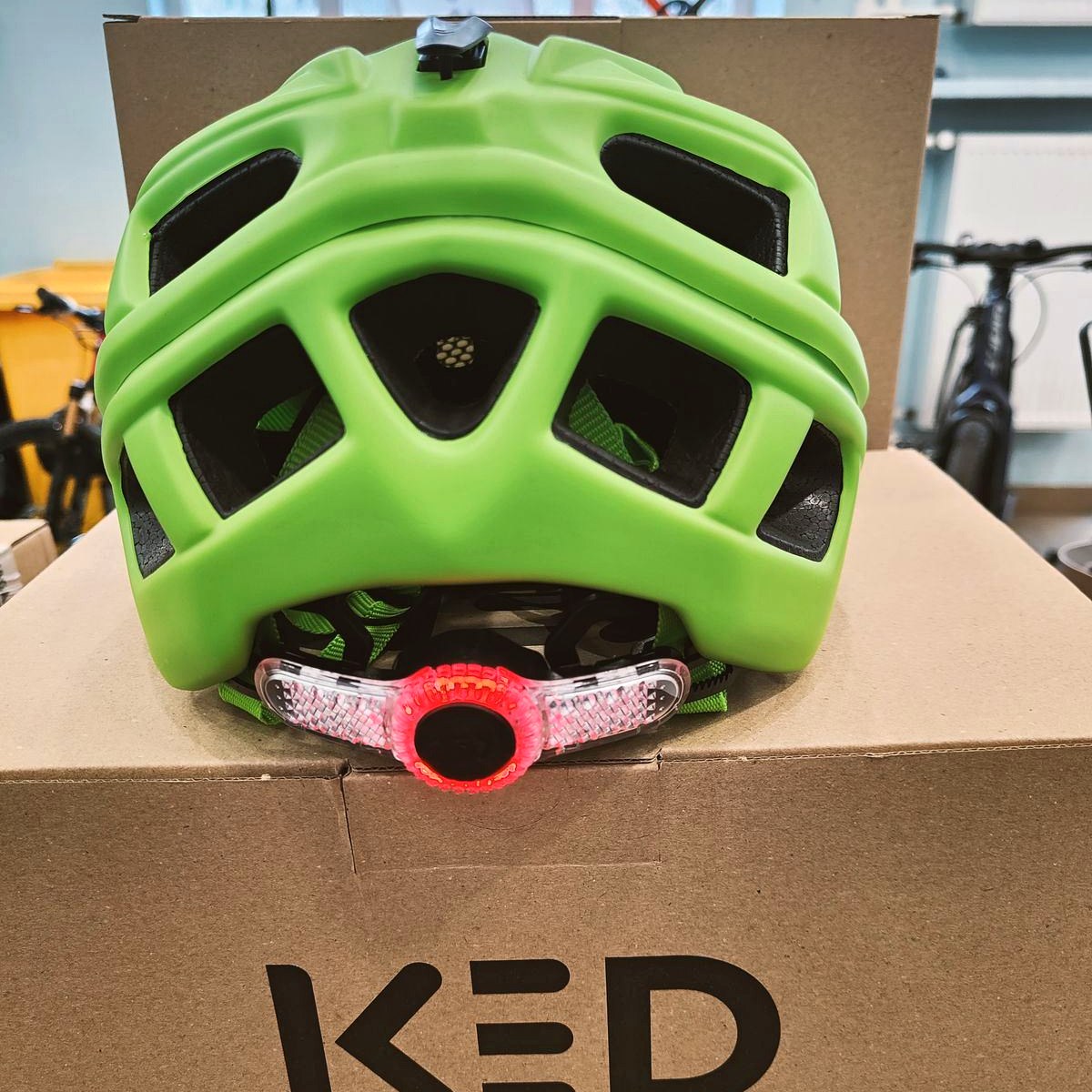 Kask dziecięcy KED Kailu zielony – tylna lampka LED włączona